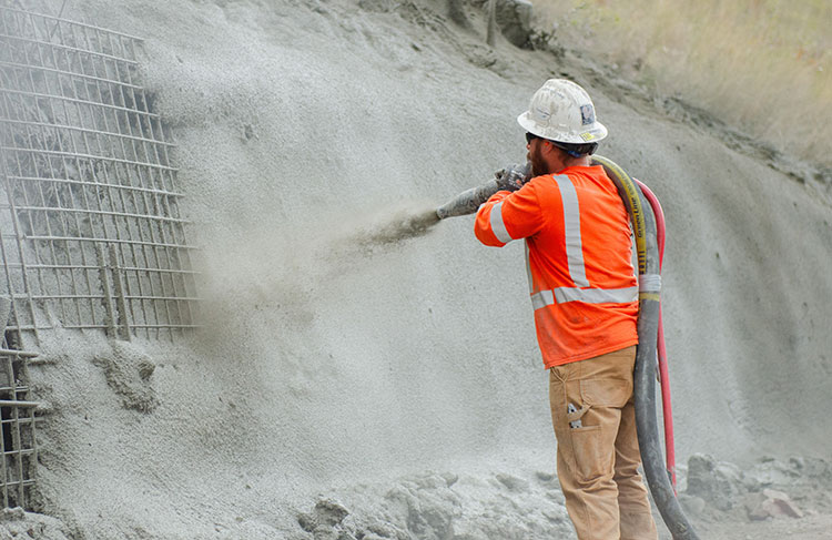 Concrete surface layer is sprayed on top of the mesh to finish the soil nail wall.