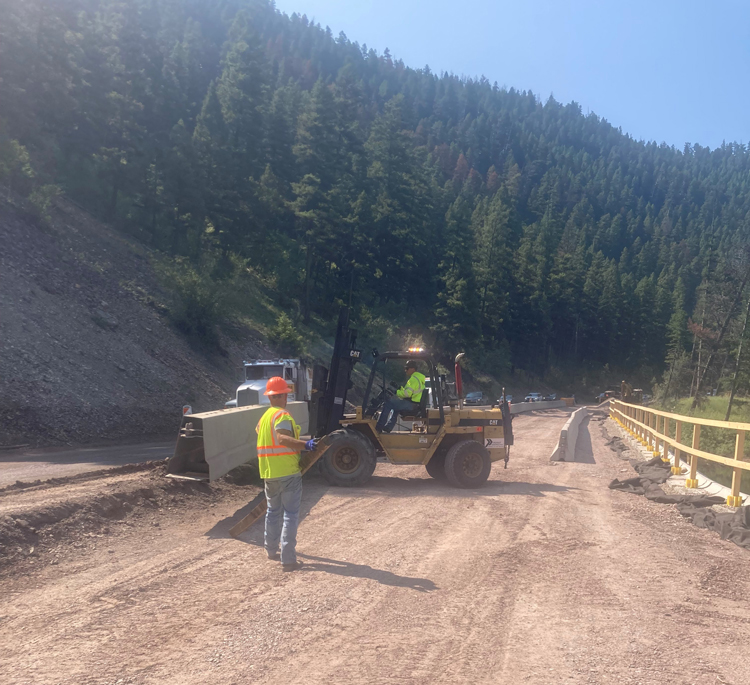 Moving the barrier to continue roadway work. 