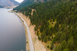 Aerial view of winding road next to a lake in Montana.