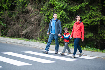 family cross street at crosswalk