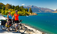 bicyclists near a lake