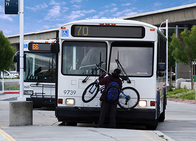 bicyclist loading bike onto bus