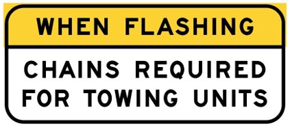 road sign that reads: when flashing, chains required for towing units