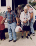 elderly individuals standing by bus