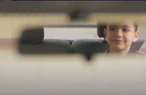 image of boy in the rearview mirror
