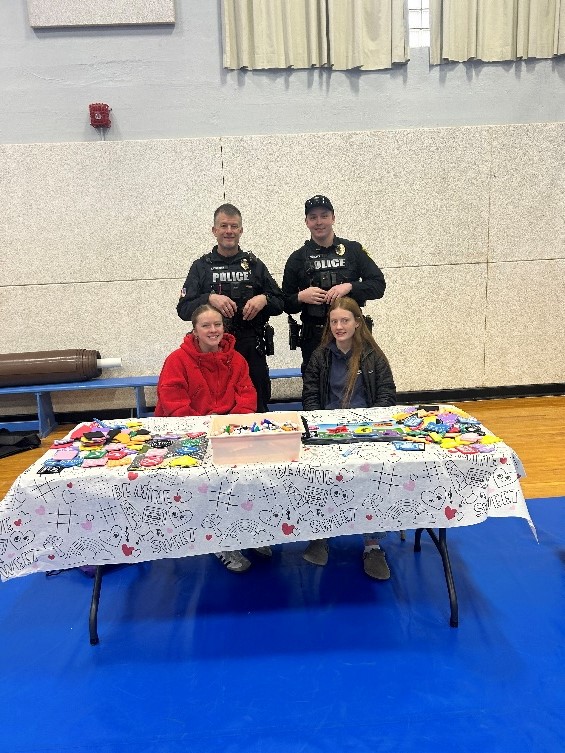 2 students participating in the Traffic Safety Gym Day along with local police